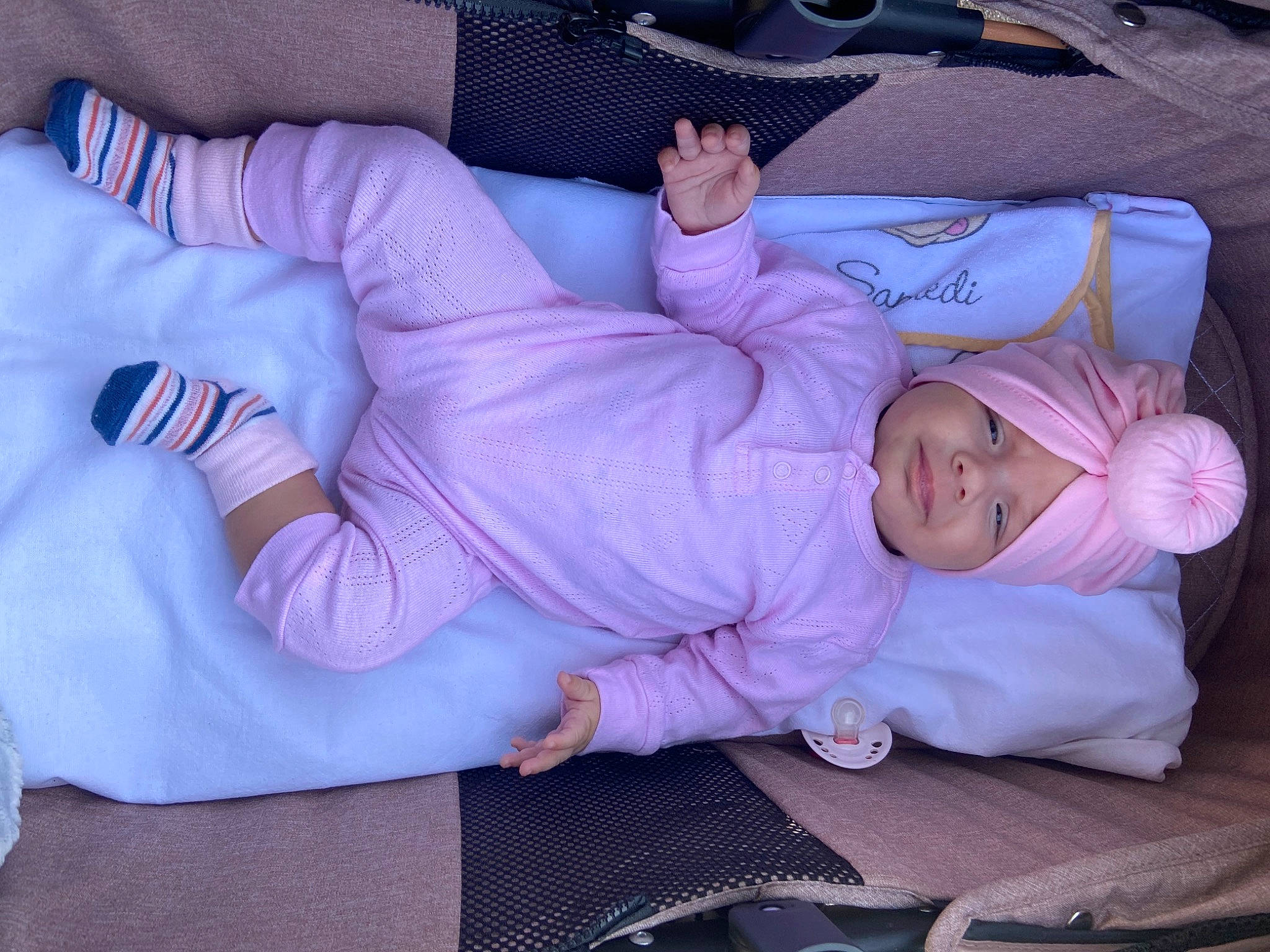 Anastasia participe au concours pour gagner de l'argent avec cette photo : baby, baby_products, baby_toddler_clothing, bedtime, child, comfort, couch, finger, gesture, headwear, human_leg, lap, linens, nap, person, pink, purple, sitting, sock, thigh