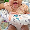 Gianna joined the competition — help win amazing prizes! baby, infant, child, smiling, headband, orange_clothing, sitting, baby_chair, colorful, indoor, happy, cute, person, toddler, furniture, patterned, skin, face, legs, toy