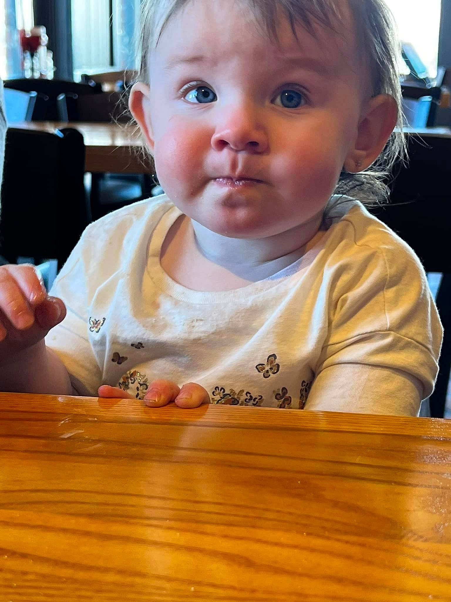 Kimber joined the competition — help win amazing prizes! baby, baby_toddler_clothing, chair, cheek, child, chin, ear, eyelash, finger, fun, hairstyle, happy, hardwood, iris, nose, person, skin, surprise, table, toddler