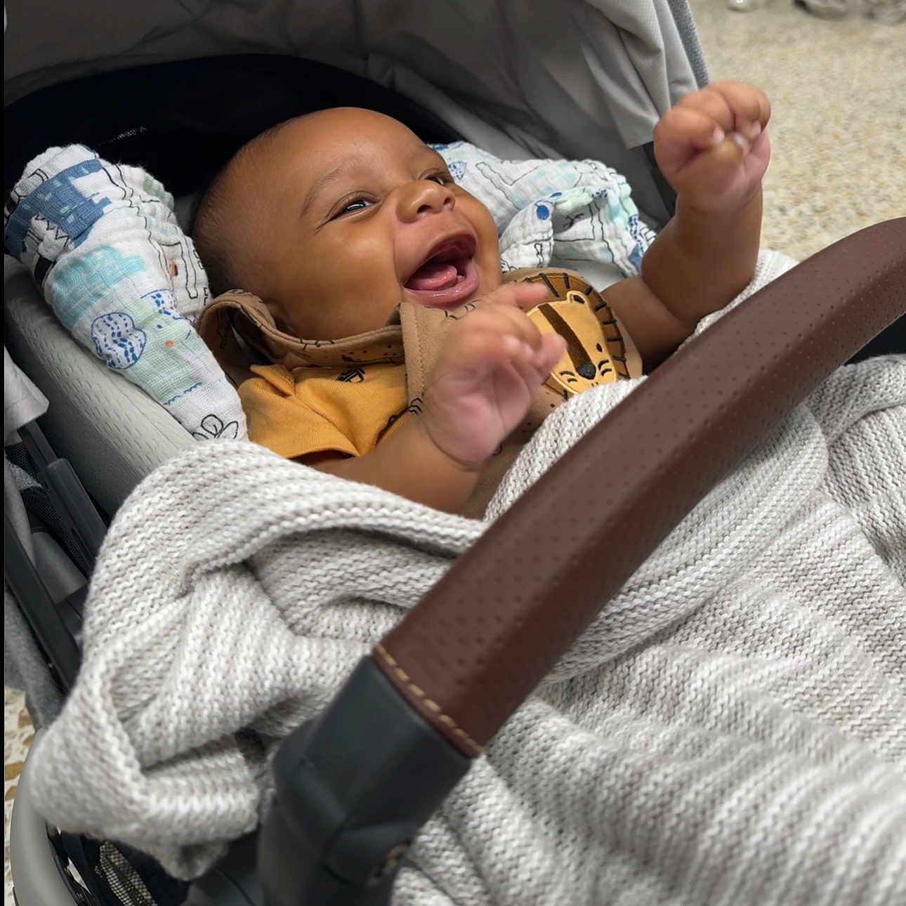 Isaac is registered to the contest to win money with this photo: baby, babylaughing, clothing, crying, face, footwear, happy, head, person, sad, shoe, smile, stroller, yawning
