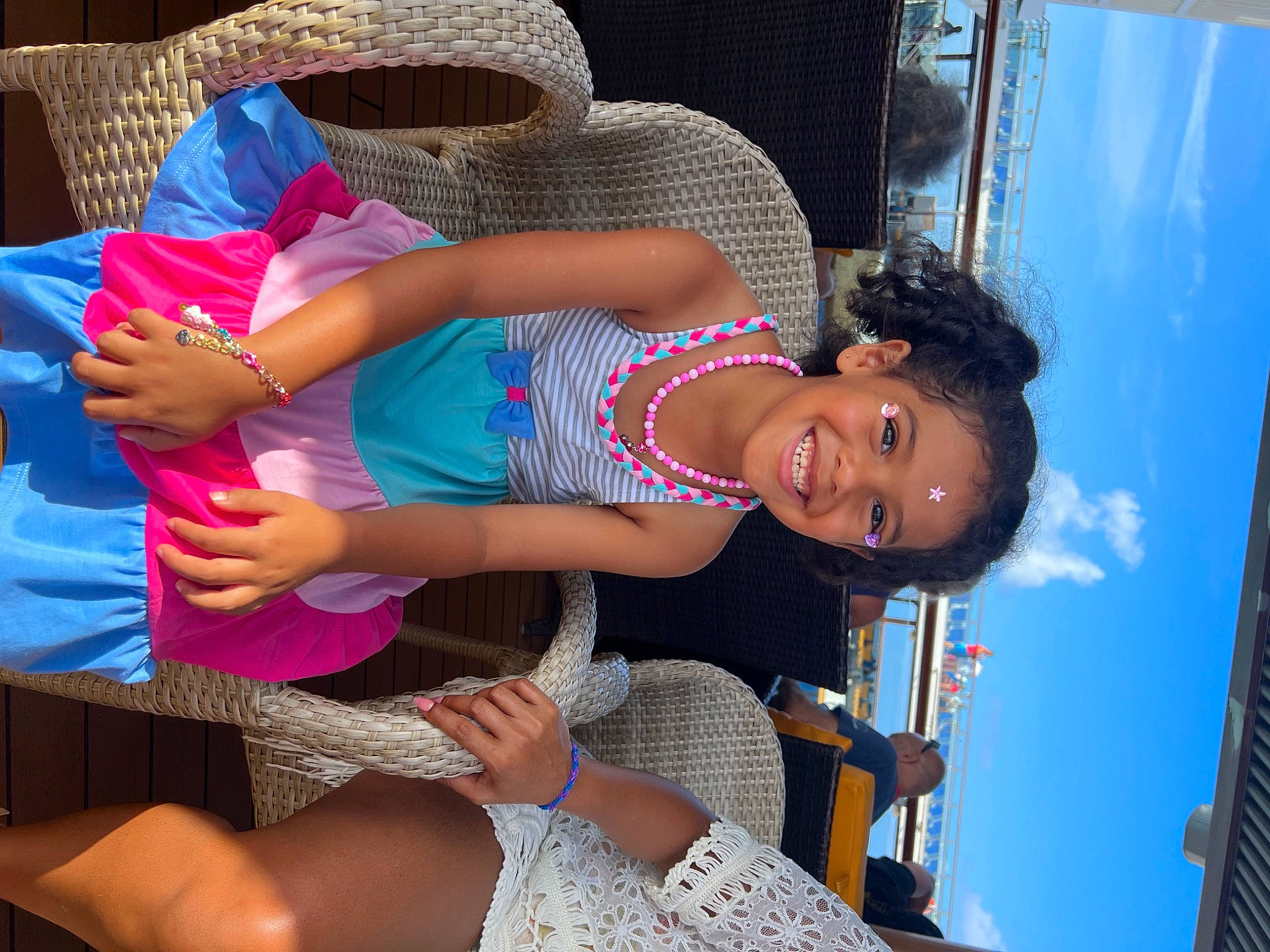 Alexandra is registered to the contest to win money with this photo: abdomen, chest, elbow, electric_blue, event, foot, fun, happy, human_body, human_leg, joy, leisure, pattern, person, pink, sandal, sky, smile, thigh, travel