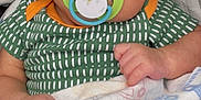 Jose Antonio joined the competition — help win amazing prizes! baby, infant, pacifier, blanket, patterned_clothing, green_shirt, hand, face, eyes, indoor, cute, sleepy, newborn, child, soft, cozy, portrait, resting, baby_boy, closeup