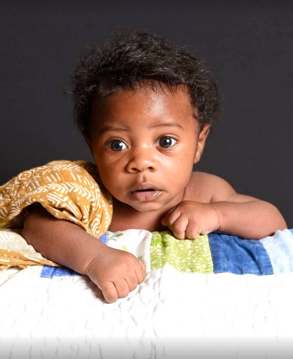 Benny is registered to the contest to win money with this photo: arm, baby, baby_toddler_clothing, cheek, close_up, comfort, eye, eyelash, finger, flash_photography, gesture, hairstyle, hand, happy, head, iris, nose, person, skin, sleeve