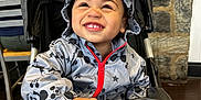 Jayceon joined the competition — help win amazing prizes! adult, baby, bonnet, chair, clothing, coat, face, female, furniture, happy, hat, head, jacket, pants, person, photography, portrait, smile, stroller, woman