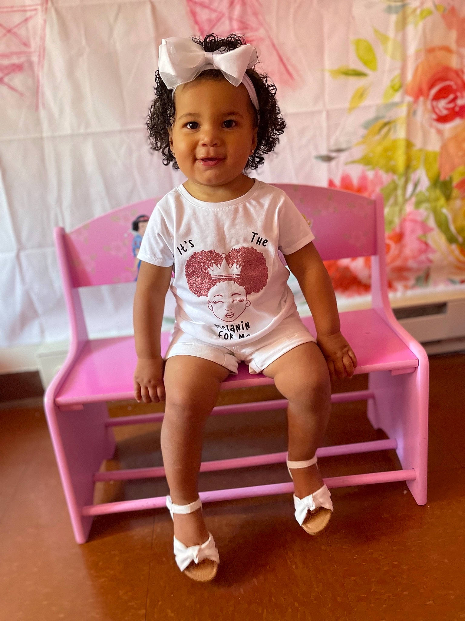 Paris is registered to the contest to win money with this photo: baby_toddler_clothing, child, fashion_accessory, happy, human_leg, joy, knee, magenta, pattern, peach, person, pink, plant, room, sitting, skin, sleeve, smile, sneakers, sock
