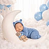 Basthian is registered to the contest to win money with this photo: newborn, baby, sleeping, portrait, blue_outfit, knitted_hat, pom_pom_hat, crescent_moon, teddy_bear, clouds, balloons, nursery, studio_photo, cozy, peaceful, infant, soft_lighting, dreamy, white_background, star_decorations