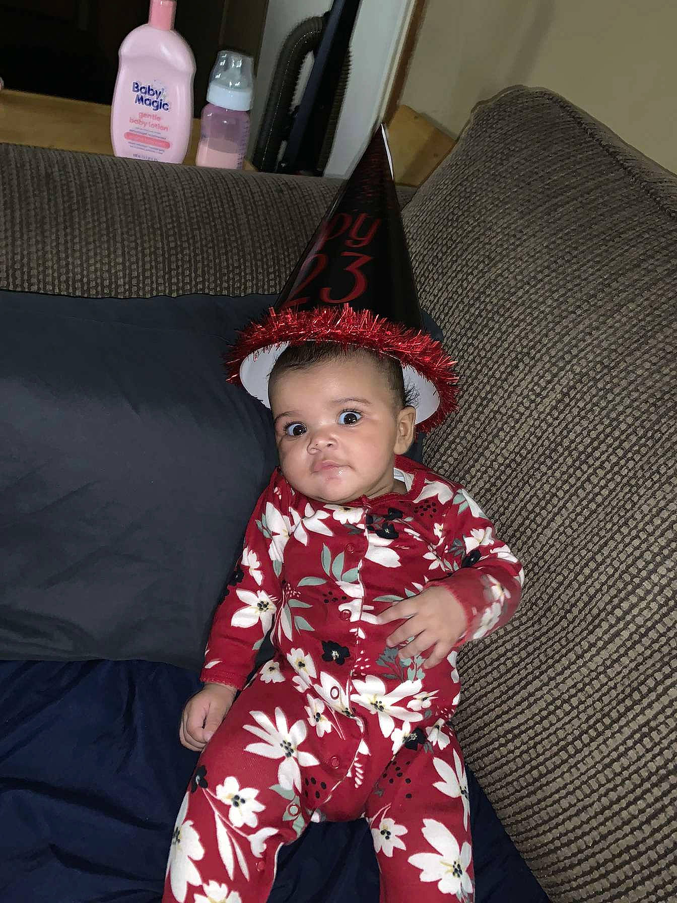 Ayana joined the competition — help win amazing prizes! baby, baby_toddler_clothing, carmine, child, comfort, costume, costume_hat, couch, event, face, fashion_accessory, flooring, fun, happy, hat, headgear, pattern, person, sitting, sleeve