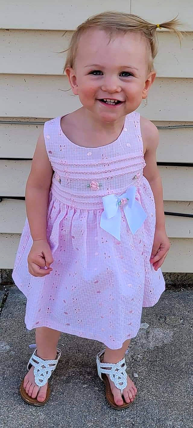 Allison is registered to the contest to win money with this photo: baby_toddler_clothing, child, cocktail_dress, day_dress, dress, embellishment, face, grass, happy, joy, neck, one_piece_garment, pattern, person, pink, skin, sleeve, smile, standing, toddler