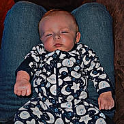 Waylon joined the competition — help win amazing prizes! baby, infant, onesie, sleepy, person, lap, clothing, pattern, stars, moon, indoor, couch, jeans, hand, face, expression, relaxing, child, home, furniture
