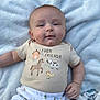 Waylon is registered to the contest to win money with this photo: baby, infant, child, blanket, outdoor, grass, clothing, shirt, pants, cute, smile, face, hand, lying_down, animal_print, farm, soft_texture, peaceful, portrait, young