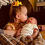 affection, arm, baby, blanket, child, couch, cozy, cute, family, home, indoor, infant, kiss, love, person, portrait, sleeping, toddler, yellow_bow, young_child
