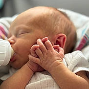 Waylon is registered to the contest to win money with this photo: baby, bottle, child, closeup, clothing, cute, ear, face, feeding, hands, human, infant, newborn, peaceful, portrait, resting, skin, sleeping, soft, white