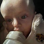 Naël P participe au concours pour gagner de l'argent avec cette photo : baby, bottle, feeding, close_up, infant, fleece_jacket, tiger_patch, face, eyes, mouth, soft_texture, child, cute, warm_clothing, indoor, portrait, young, skin, head, expression