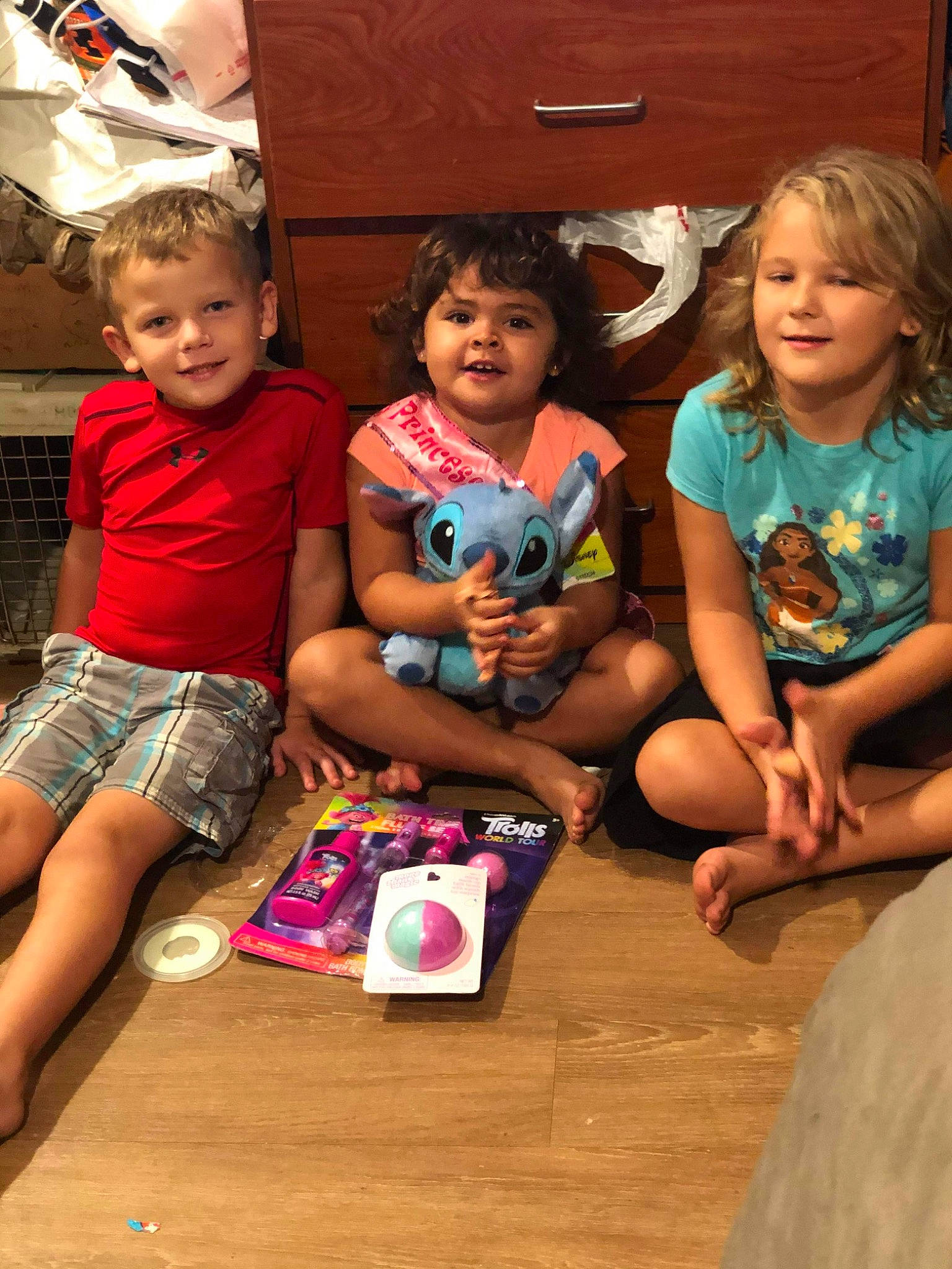 Melanie is registered to the contest to win money with this photo: child, event, flooring, fun, happy, interaction, joy, lap, leisure, person, play, room, sharing, shorts, sitting, skin, smile, standing, t_shirt, thigh