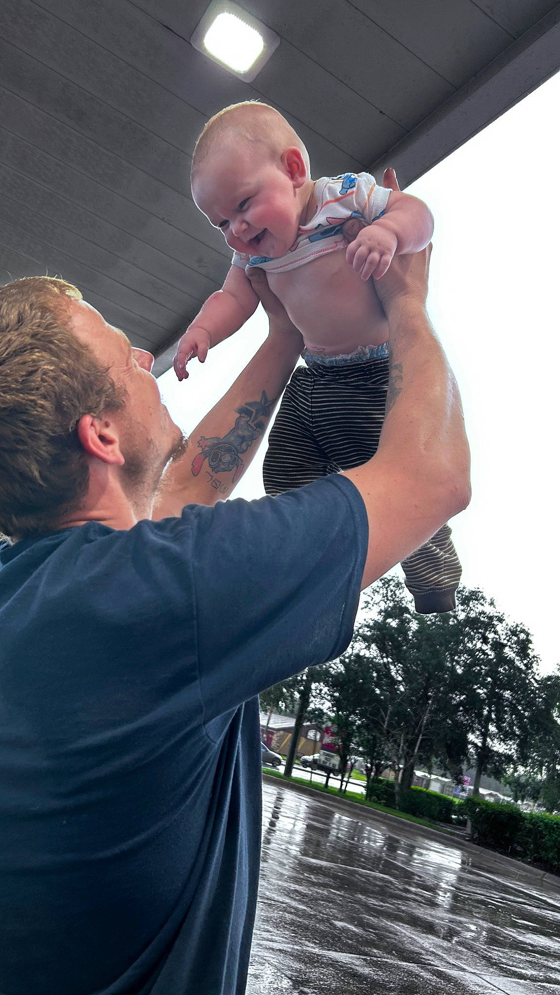Gracelynn is registered to the contest to win money with this photo: arm, chest, elbow, event, finger, flash_photography, fun, gesture, hand, happy, human, leisure, muscle, person, recreation, shorts, sky, t_shirt, toddler, tree