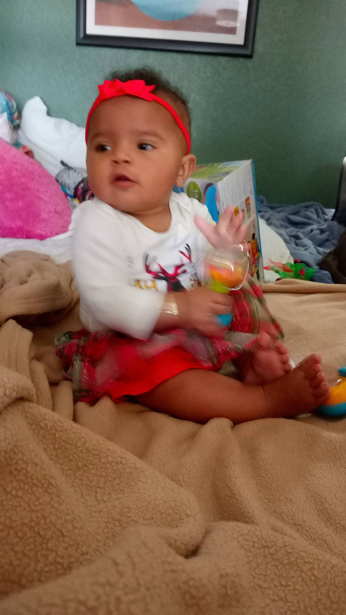 Asia is registered to the contest to win money with this photo: baby, baby_toddler_clothing, carmine, cheek, child, comfort, foot, fun, happy, human_leg, knee, linens, person, pink, room, shorts, sitting, skin, sock, thigh