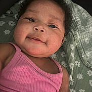Autumn joined the competition — help win amazing prizes! baby, smiling, face, pink_clothing, curly_hair, close_up, blanket, floral_pattern, infant, cute, child, portrait, skin, happy, laying_down, indoors, person, young, head, cheeks
