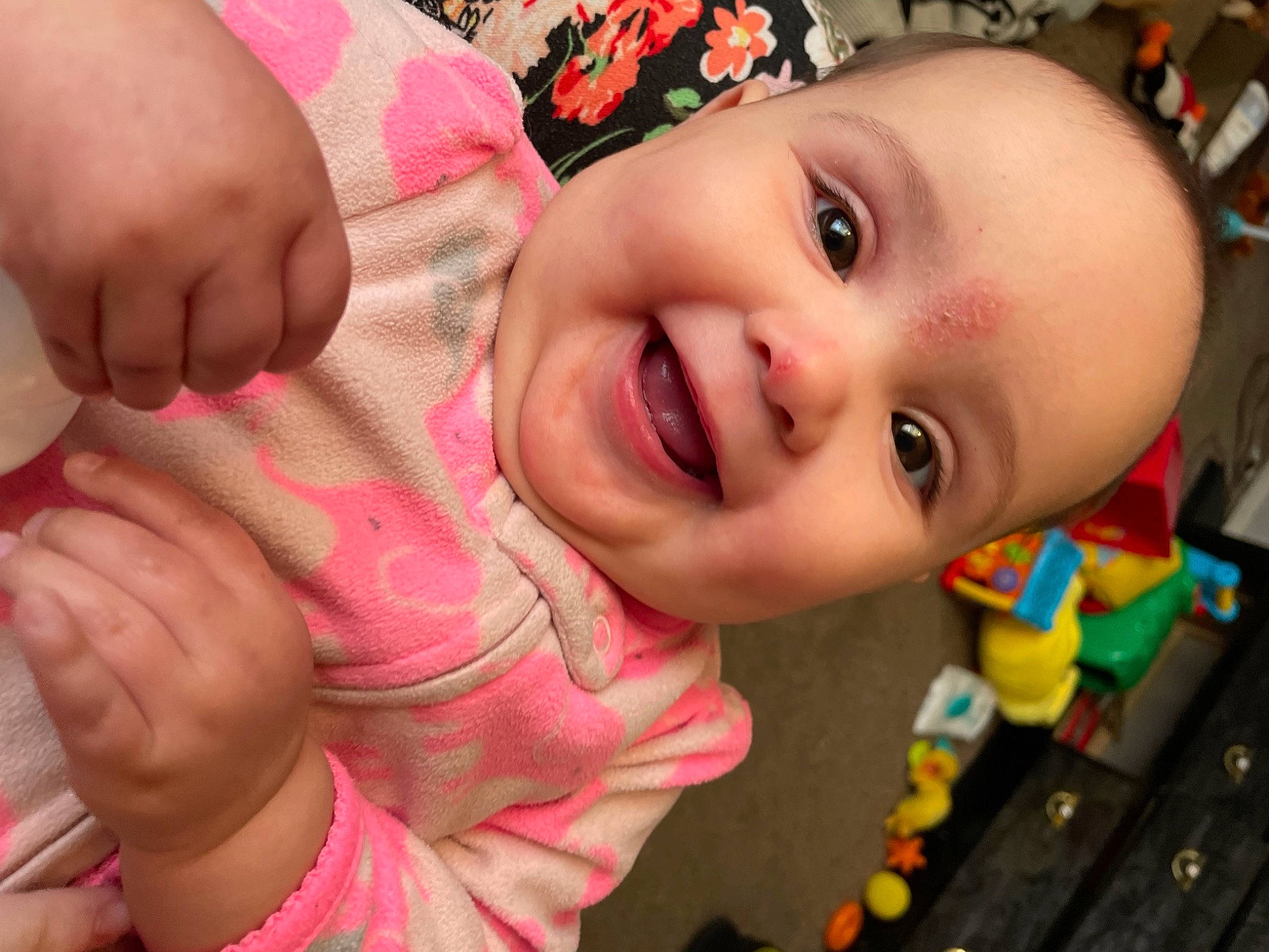 Octavia is registered to the contest to win money with this photo: baby, cheek, chin, eye, eyelash, face, facial_expression, finger, gesture, happy, head, human, human_body, iris, joy, lip, mouth, nose, person, pink