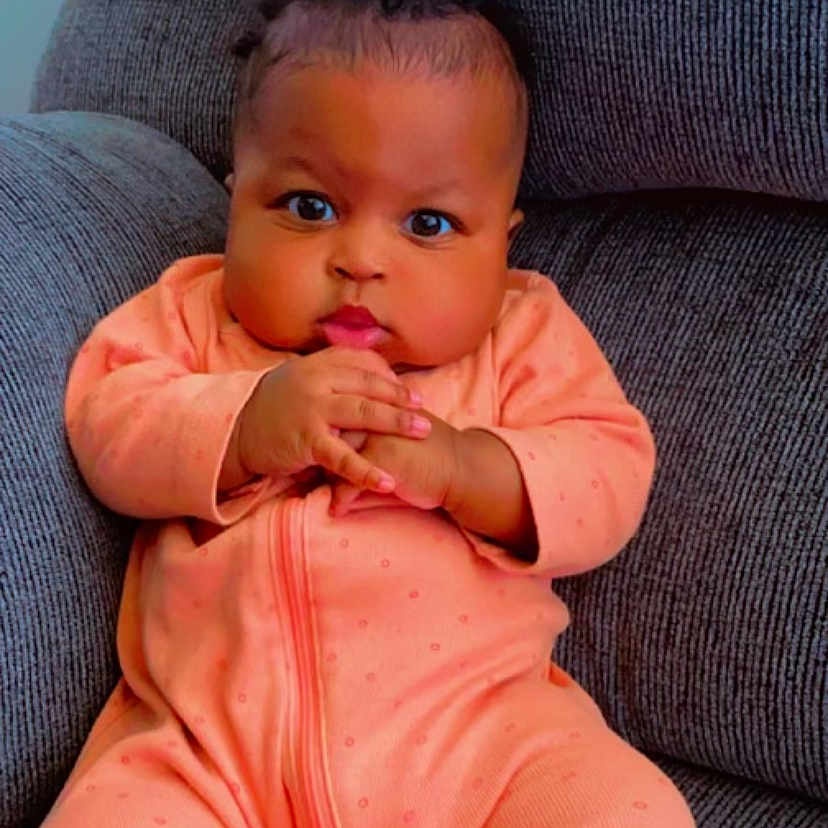 Damyla is registered to the contest to win money with this photo: baby, bodypart, chair, clothing, couch, cushion, face, finger, furniture, hand, happy, head, homedecor, newborn, pants, person, photography, portrait, sitting, smile