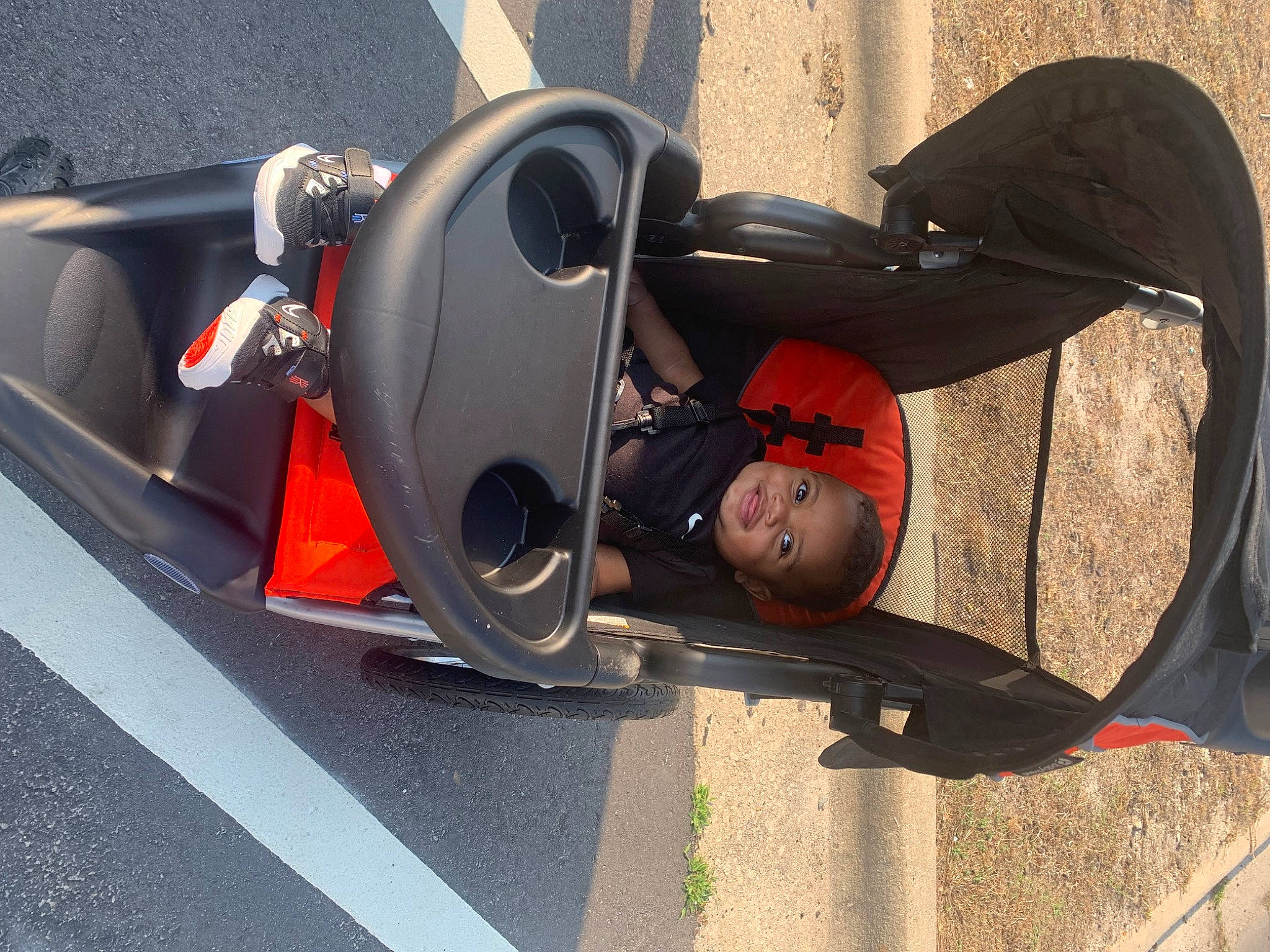 Kyrie is registered to the contest to win money with this photo: asphalt, audio_equipment, auto_part, automotive_design, automotive_exterior, automotive_lighting, automotive_tire, automotive_wheel_system, bumper, carmine, concrete, fender, gas, motor_vehicle, person, personal_protective_equipment, rim, road_surface, rolling, vehicle