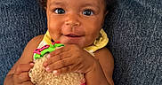 Jaxlynn is registered to the contest to win money with this photo: baby, child, smiling, toy, stuffed_animal, watermelon, couch, blue_couch, indoor, happy, cute, portrait, person, hand, clothing, fabric, furniture, infant, closeup, playful