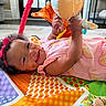 Jaxlynn joined the competition — help win amazing prizes! baby, infant, smiling, play_mat, toy, headband, colorful, indoor, crawling, child, cute, happy, hands, face, patterned_clothing, floor, soft_toy, bright, cheerful, young