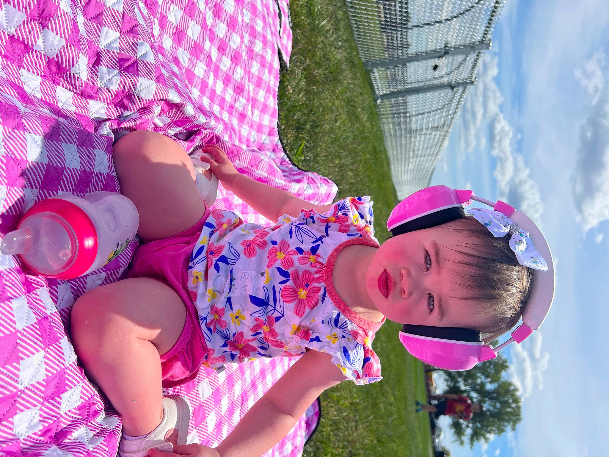 Evie joined the competition — help win amazing prizes! arm, cloud, facial_expression, fedora, fun, grass, happy, hat, headgear, leisure, magenta, people_in_nature, person, pink, plant, purple, skin, sky, sun_hat, toddler