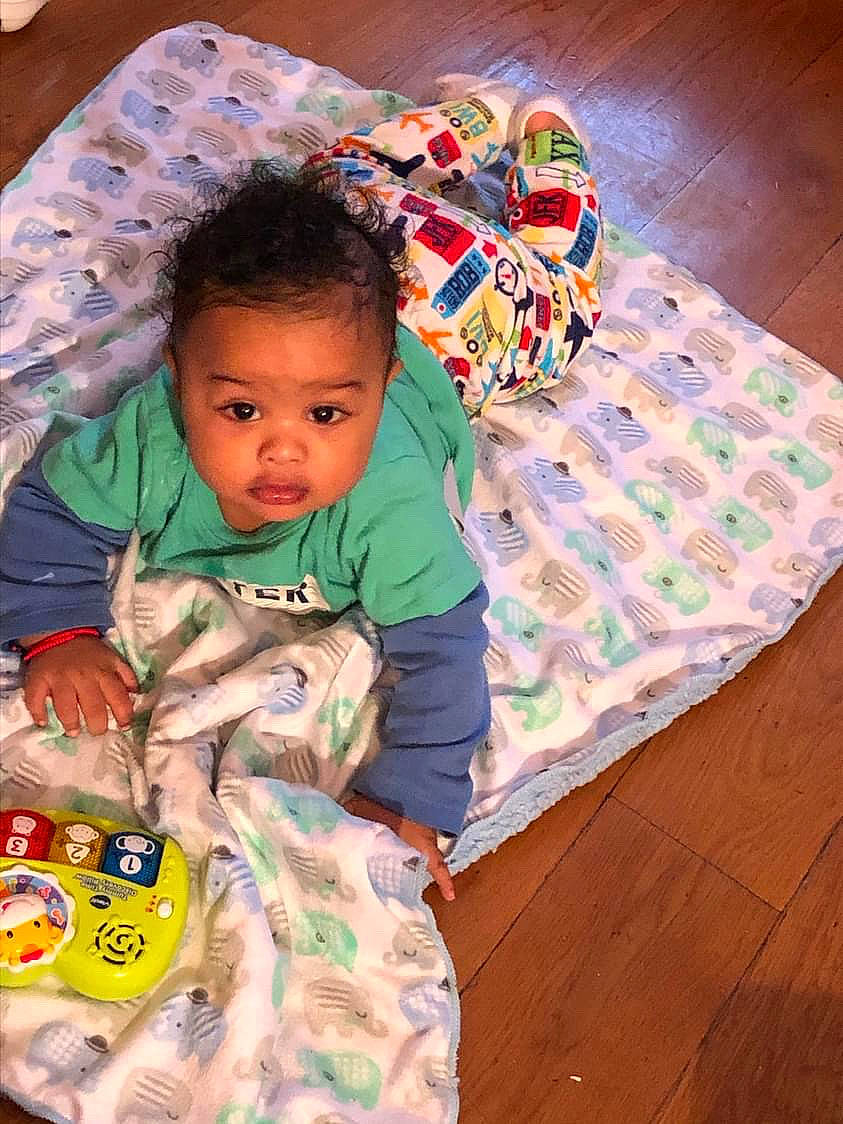 Mateo joined the competition — help win amazing prizes! baby, baby_products, baby_toddler_clothing, child, comfort, flooring, fun, happy, hardwood, linens, pattern, person, play, room, sitting, skin, sleeve, t_shirt, toddler, wood