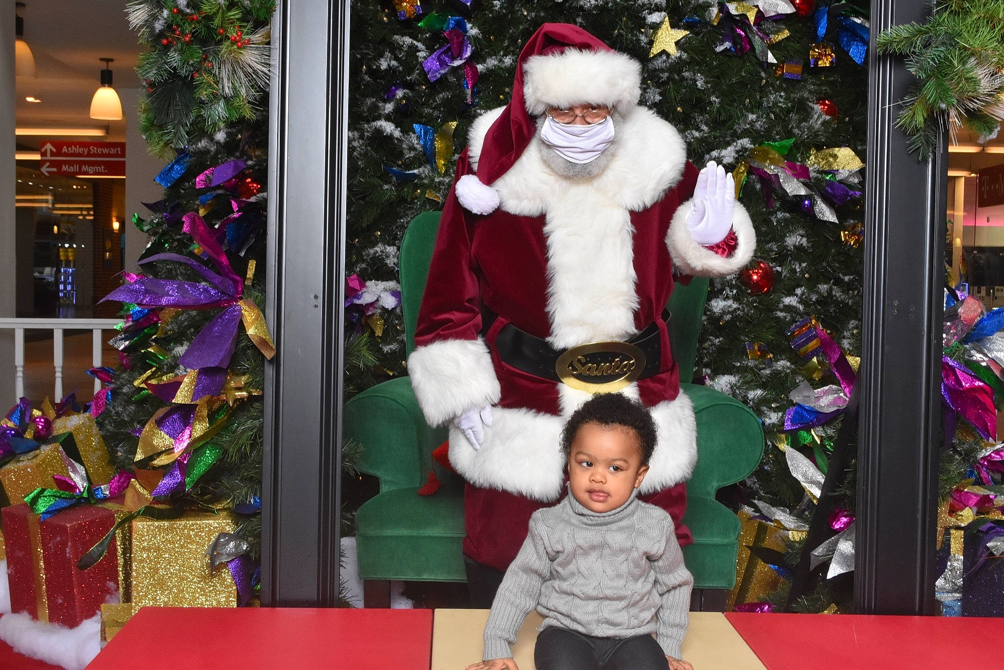 Mateo is registered to the contest to win money with this photo: beard, christmas, christmas_decoration, christmas_ornament, christmas_tree, event, fun, green, happy, hat, holiday, holiday_ornament, jacket, ornament, outerwear, person, photograph, santa_claus, standing, toddler