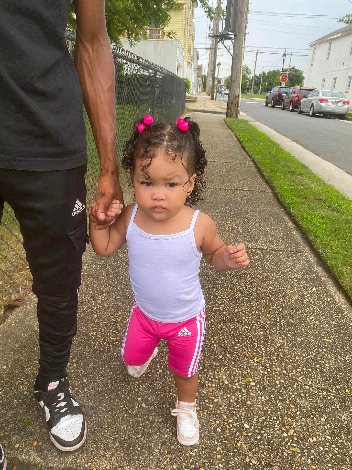 Safira is registered to the contest to win money with this photo: alley, child, city, clothing, face, footwear, grass, head, path, person, photography, plant, portrait, road, shoe, shorts, sidewalk, street, urban, walking