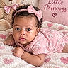 Aleena is registered to the contest to win money with this photo: adorable, baby, bed, blanket, child, close_up, curly_hair, cute, floral_clothing, hair_bow, indoors, infant, little_princess, lying_down, nursery, pillow, pink_outfit, portrait, smiling, teddy_bear