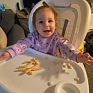Brayleanna joined the competition — help win amazing prizes! baby, child, high_chair, infant, smiling, happy, sitting, portrait, face, eyes, pink_sweater, long_hair, food, snacks, puff_snacks, feeding, tray, indoor, home, fan
