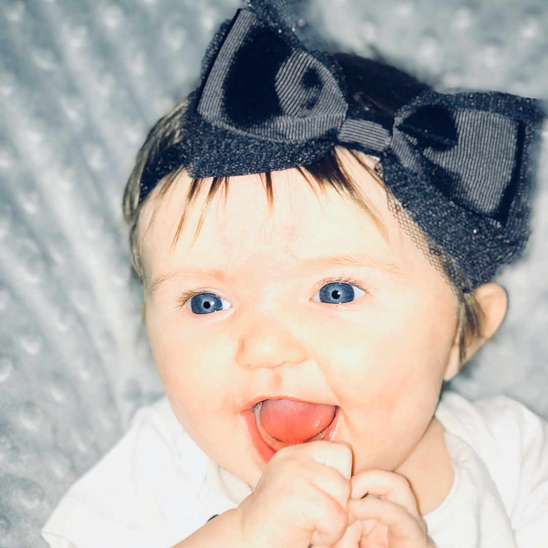 Jayme is registered to the contest to win money with this photo: black_hair, cheek, child, eye, forehead, fun, girl, hair_accessory, happiness, head, headgear, infant, lip, nose, portrait, portrait_photography, product, skin, smile, toddler