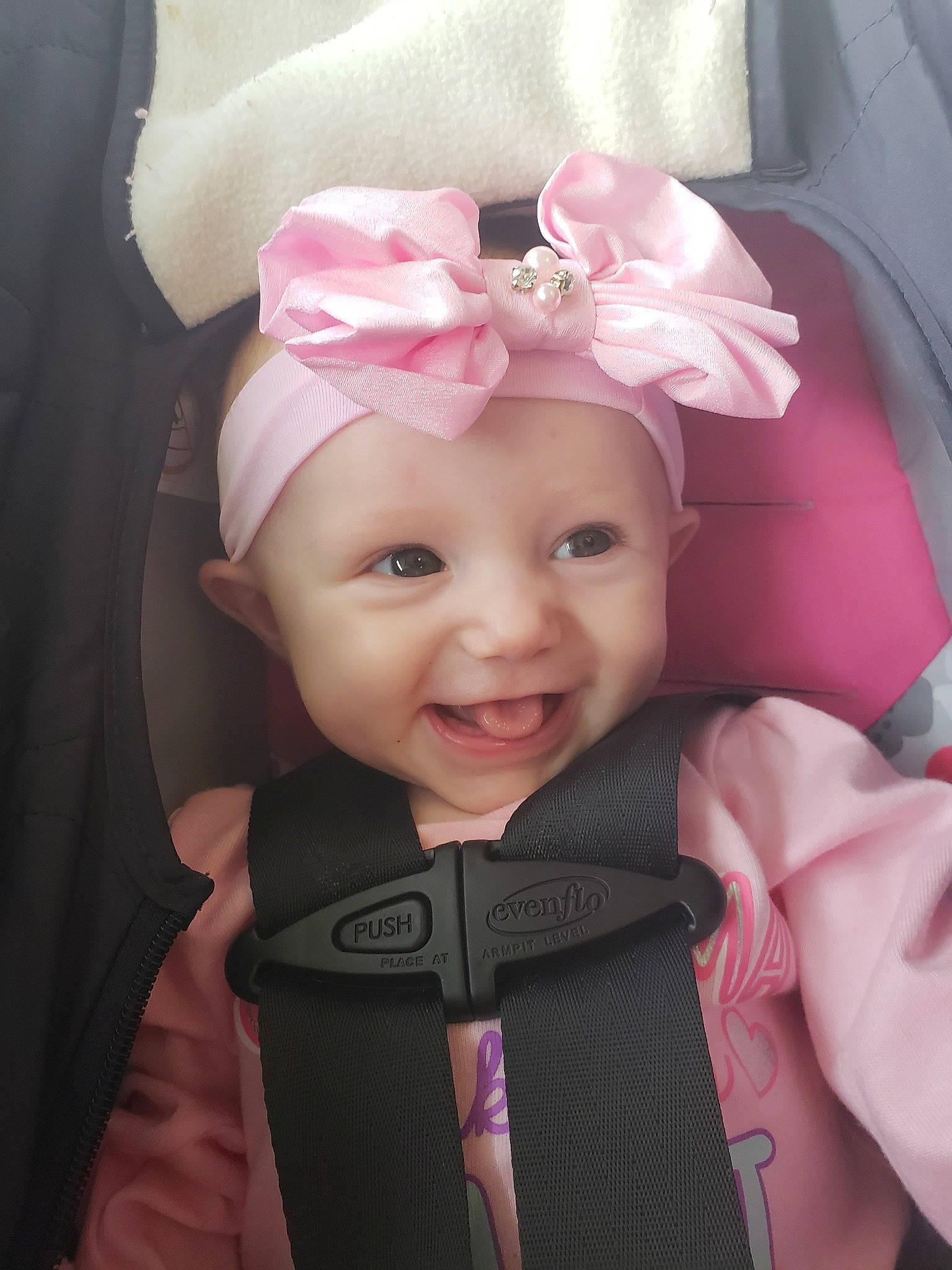 Allie is registered to the contest to win money with this photo: baby, beauty, cheek, child, ear, eye, face, forehead, fun, hair_accessory, head, headgear, joy, lip, nose, person, pink, plant, product, skin