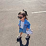 child, girl, outdoor, parking_lot, sunglasses, denim_jacket, denim_skirt, bow, handbag, cherries, shoes, fashion, street_style, sunlight, shadow, asphalt, cars, portrait, standing, full_body