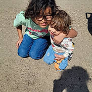 Braxton joined the competition — help win amazing prizes! child, children, sand, outdoor, toy_car, glasses, hugging, kneeling, casual_clothing, blue_jeans, sweater, daylight, playtime, happy, cute, smiling, friends, shadows, sunny, closeup