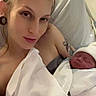 mother, newborn, baby, hospital_bed, blanket, swaddle, woman, tattoo, piercing, bed, hospital, sleeping, infant, person, portrait, skin, headwear, indoor, parent, love