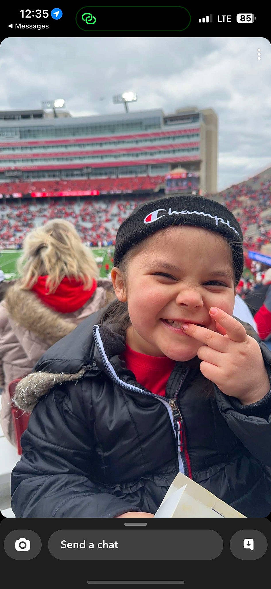 Jocelyn is registered to the contest to win money with this photo: cap, crowd, event, facial_expression, fan, fun, fur, gesture, glove, happy, headgear, headwear, jacket, joy, leisure, lip, outerwear, person, recreation, smile