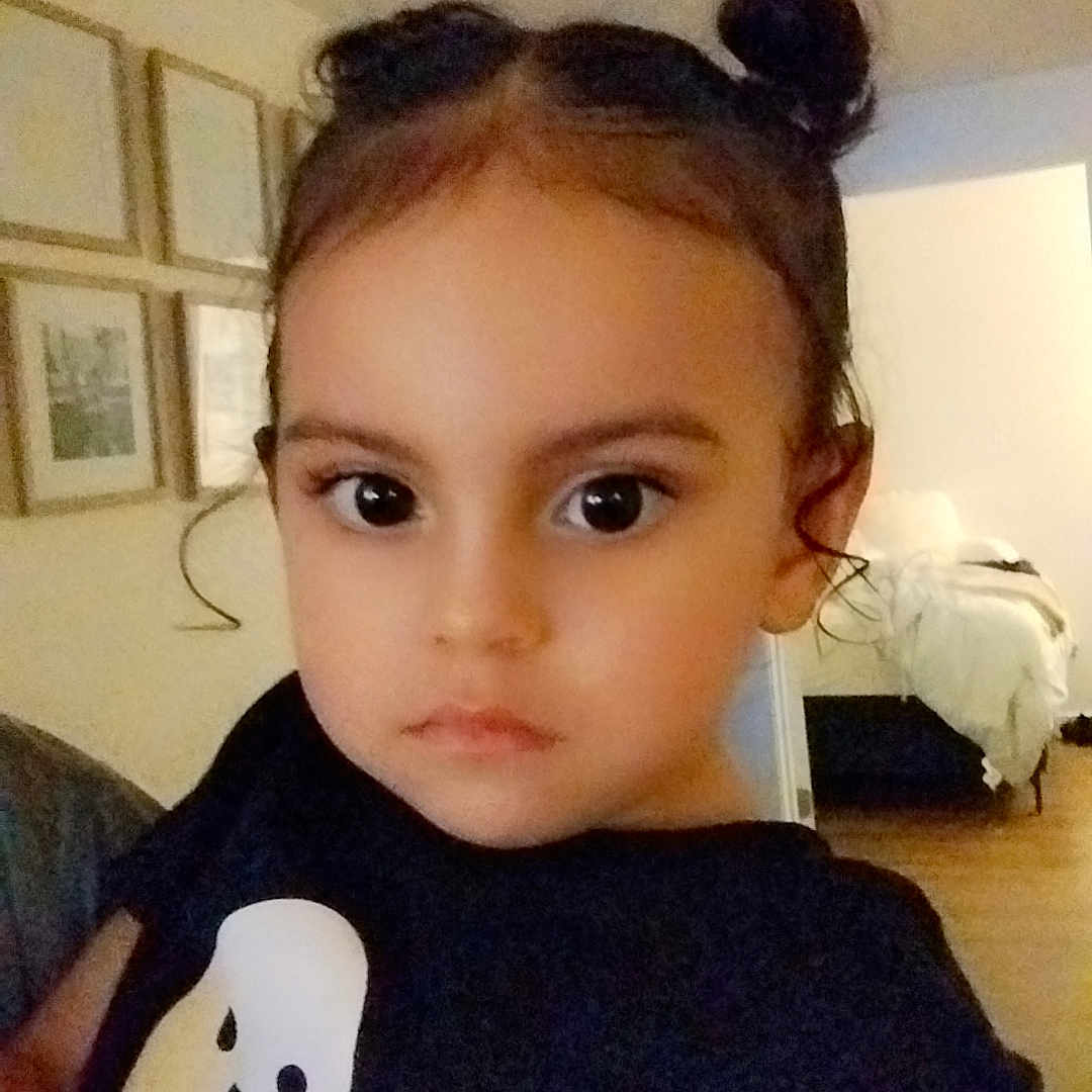 Addyson is registered to the contest to win money with this photo: animal, baby, bird, bodypart, clothing, couch, cushion, face, finger, furniture, hand, head, homedecor, indoors, penguin, person, photoframe, photography, portrait, t_shirt