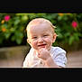 Mason is registered to the contest to win money with this photo: toddler, child, smiling, face, outdoor, greenery, flower, happy, person, portrait, cute, baby, nature, blond_hair, young_child, casual_clothing, sunlight, skin, emotion, cheerful