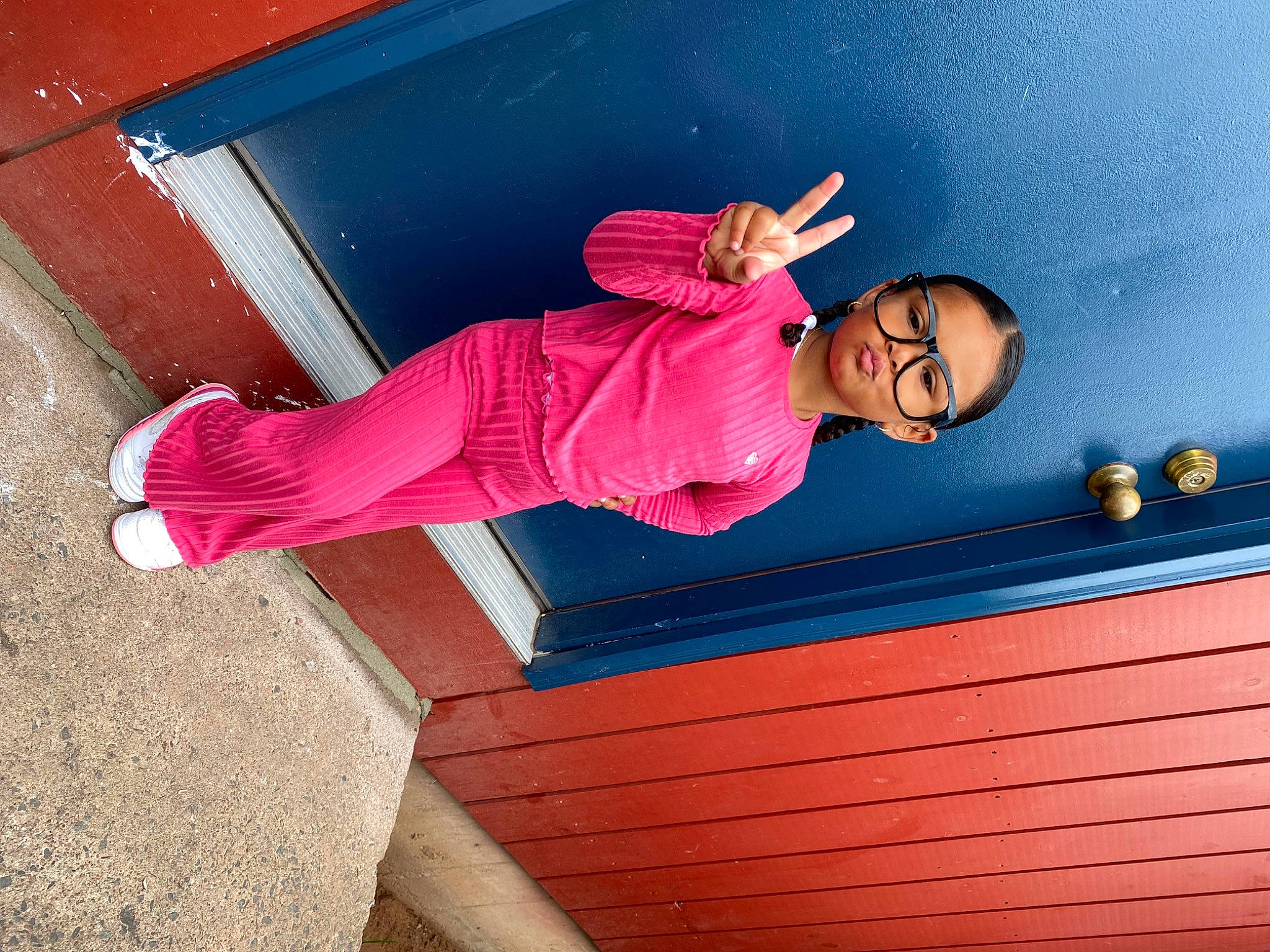 Leah is registered to the contest to win money with this photo: blue, door, elbow, fun, glasses, happy, jeans, leisure, magenta, orange, person, pink, plant, purple, stairs, standing, sunglasses, t_shirt, tints_and_shades, wall