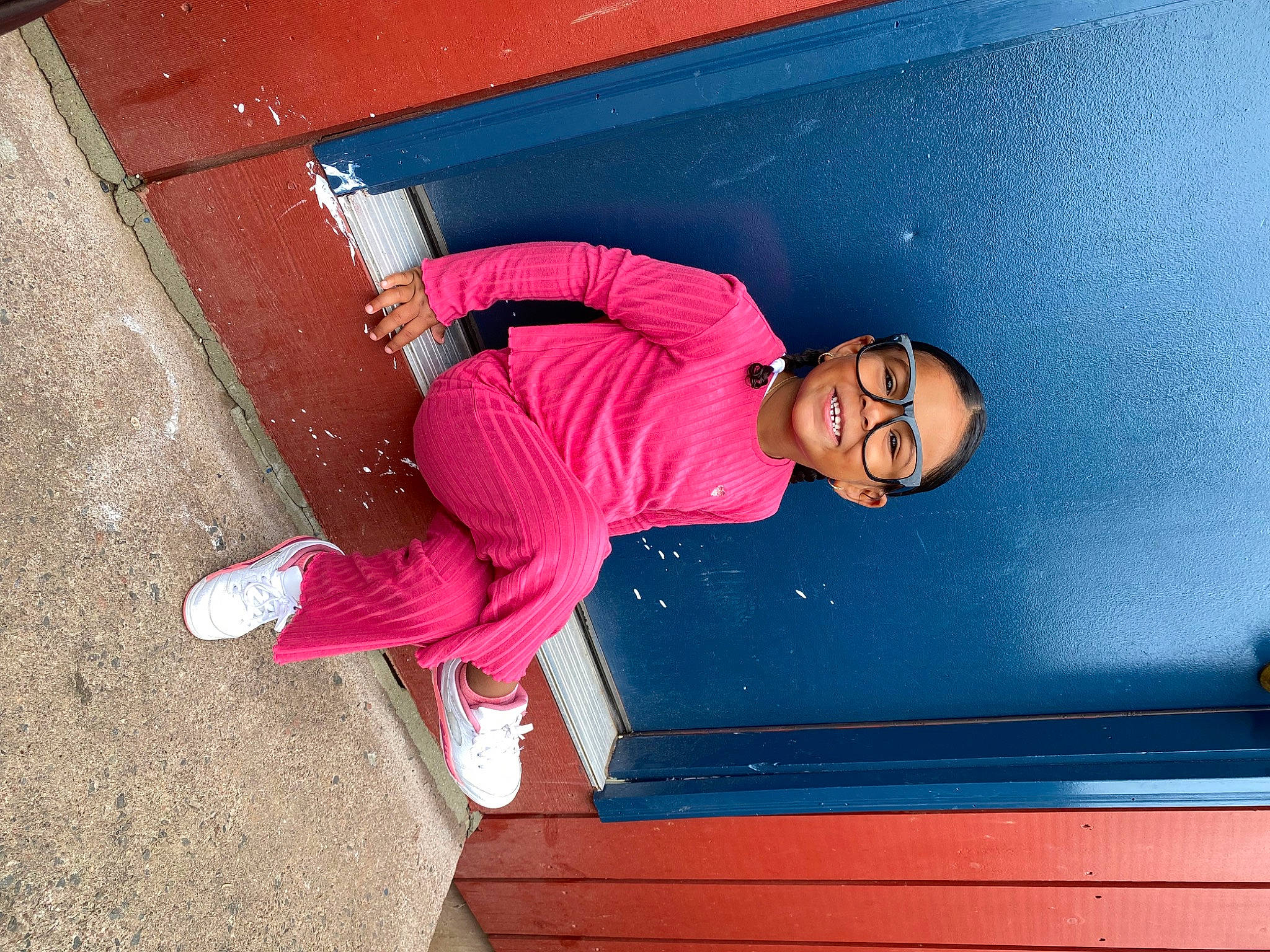 Leah is registered to the contest to win money with this photo: blue, electric_blue, eyewear, fun, hat, helmet, human_leg, joy, knee, leg, leisure, magenta, outdoor_shoe, person, pink, sitting, stairs, sunglasses, t_shirt, tints_and_shades