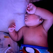 Tommy is registered to the contest to win money with this photo: baby, bed, blanket, child, colorful, comfort, cozy, cute, face, hand, indoor, infant, peaceful, pillow, resting, skin, sleeping, soft_lighting, superhero, toddler