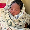 Nikko joined the competition — help win amazing prizes! newborn, baby, infant, sleeping, swaddled, blanket, hospital, portrait, face, closed_eyes, dark_hair, peaceful, cozy, medical_card, indoors, seated, textile, patterned_blanket, caregiver, family
