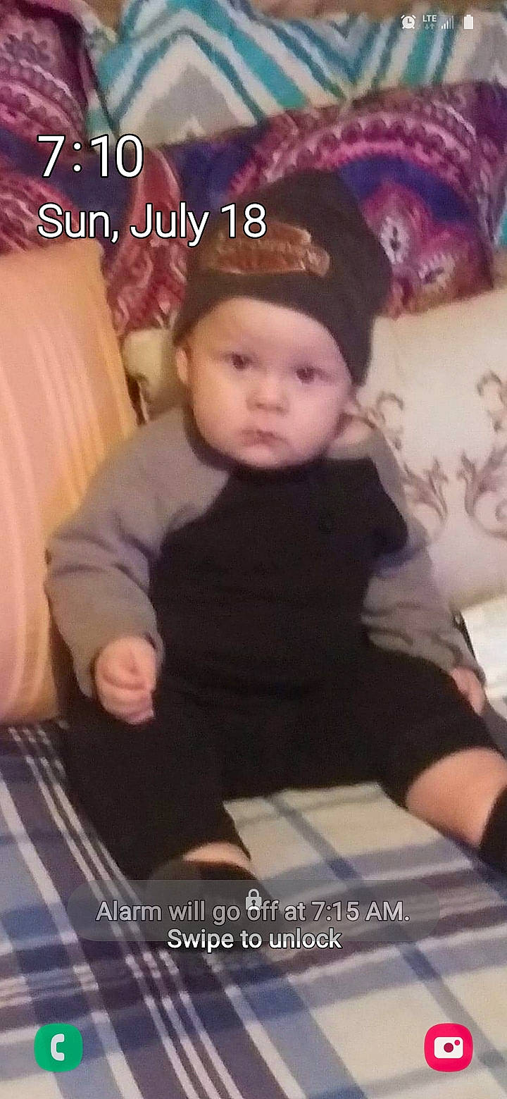 Hayden is registered to the contest to win money with this photo: baby, baby_toddler_clothing, baseball_cap, beanie, cap, car_seat, child, comfort, fashion_accessory, fun, happy, headwear, human_leg, knit_cap, lap, pattern, person, photo_caption, sitting, sleeve