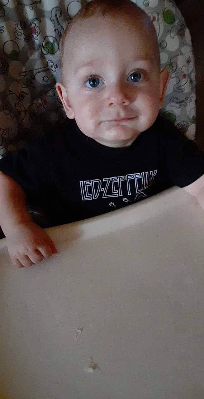 Chandler is registered to the contest to win money with this photo: baby, baby_toddler_clothing, cheek, child, chin, comfort, elbow, eyebrow, eyelash, facial_expression, fun, happy, neck, person, room, sitting, skin, sleeve, smile, t_shirt