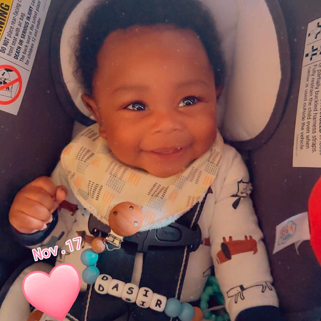 Dasir is registered to the contest to win money with this photo: baby, bodypart, car, car_interior, carseat, clothing, cushion, face, finger, furniture, hand, happy, hat, head, person, photography, portrait, smile, transportation, vehicle