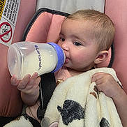 Jaazaniah joined the competition — help win amazing prizes! baby, infant, child, car_seat, bottle, milk, feeding, blanket, plush_blanket, cow_pattern, pacifier, hand, face, eyes, hair, sitting, indoor, portrait, pink, safe