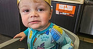 Kole joined the competition — help win amazing prizes! toddler, child, burger_king_crown, high_chair, fast_food, pajamas, food, french_fry, restaurant, curious_expression, indoor, table, napkin, red_wall, sign, smile, person, face, seat, cute