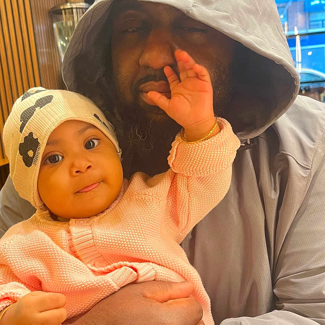 Marie joined the competition — help win amazing prizes! adult, baby, child, closeup, cute, expression, face, family, hand, hat, holding, hoodie, indoor, interaction, love, person, playful, skin, sweater, warm_lighting